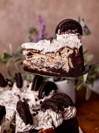 Taking a slice out of the Oreo cake cheesecake.