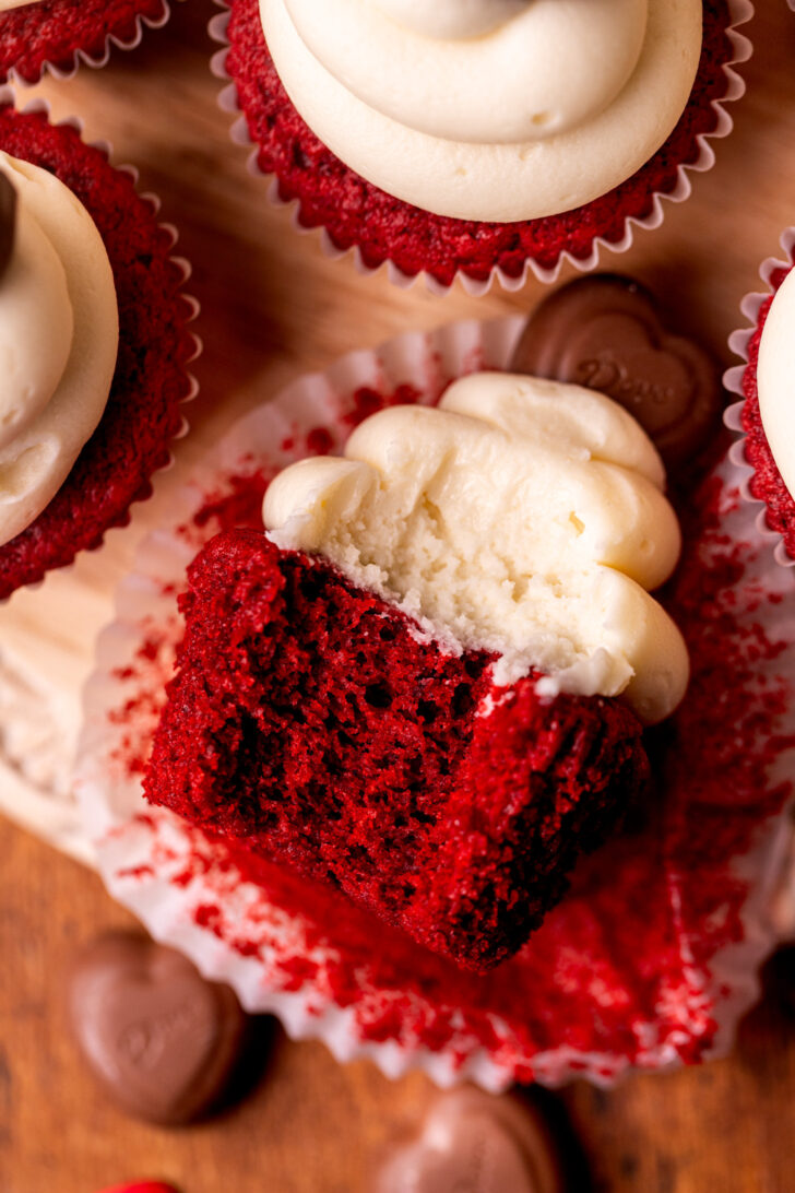 Bite missing from cupcake on its side.