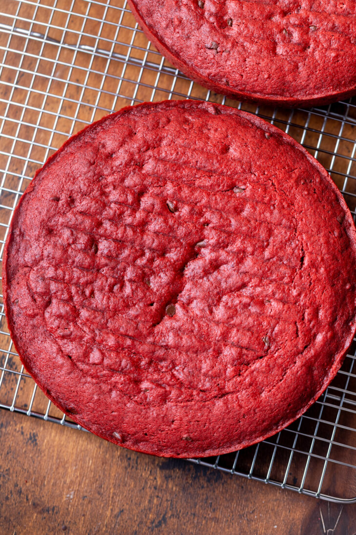 Red velvet cake on a wire rack.