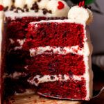 Taking a slice out of red velvet chocolate chip cake.