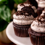 Decorated Oreo cupcakes on a cake stand.