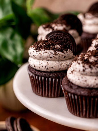 Decorated Oreo cupcakes on a cake stand.