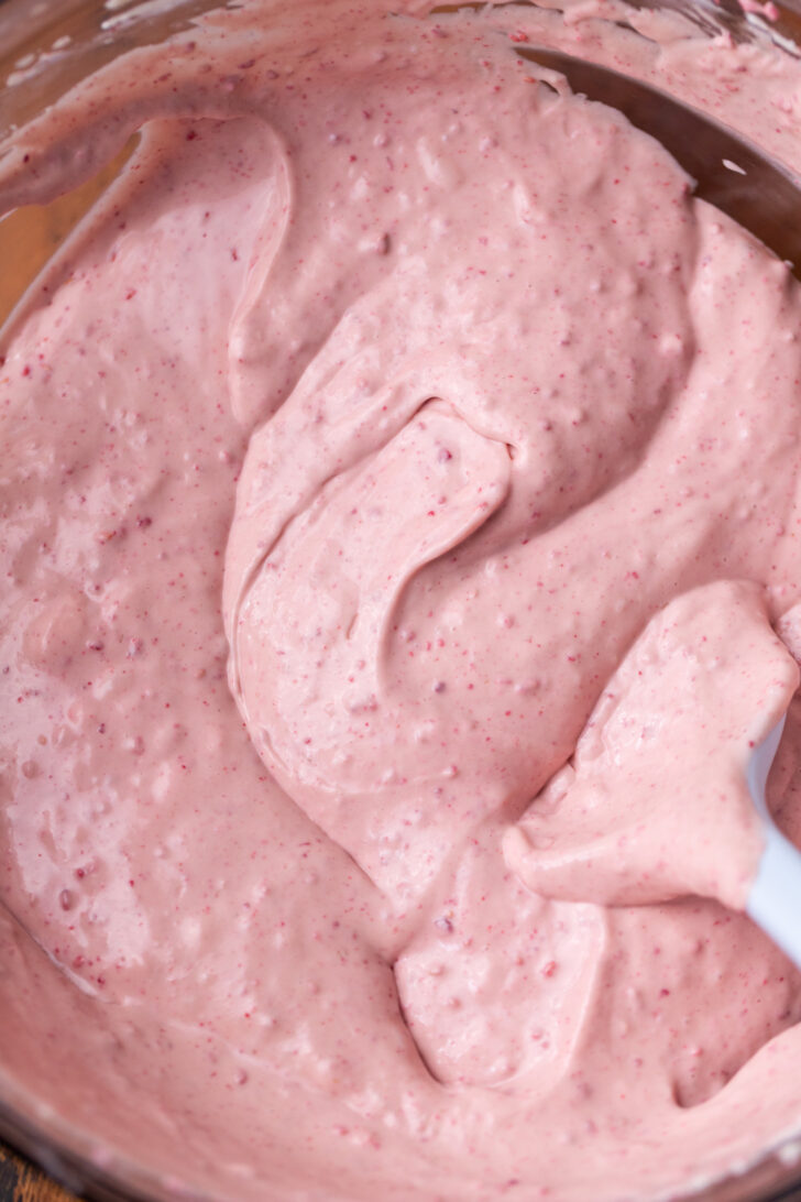 Raspberry cheesecake batter in a bowl.