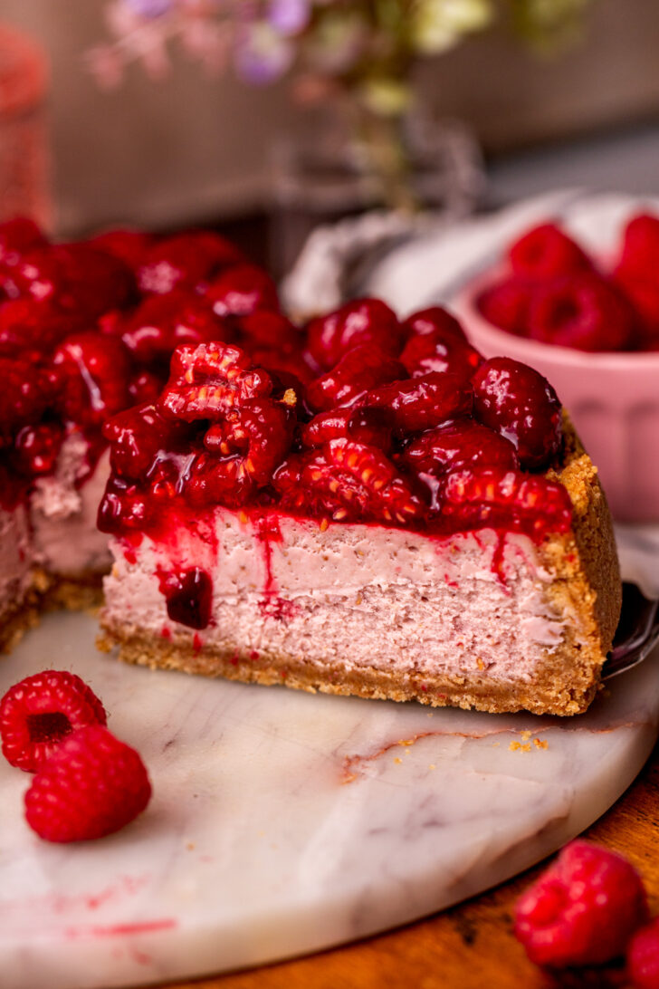 Taking a slice out of the raspberry cheesecake.