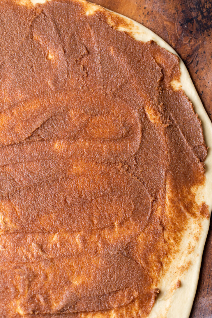 Cinnamon filling on top of the dough.