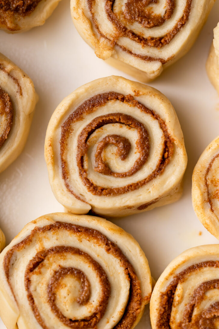 Top view of raw cinnamon roll in pan.