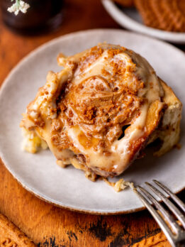 One Biscoff cinnamon roll on a plate.