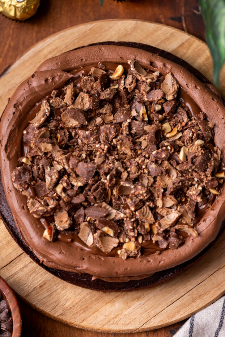 Chopped ferrero rocher pieces on top of cake layer.