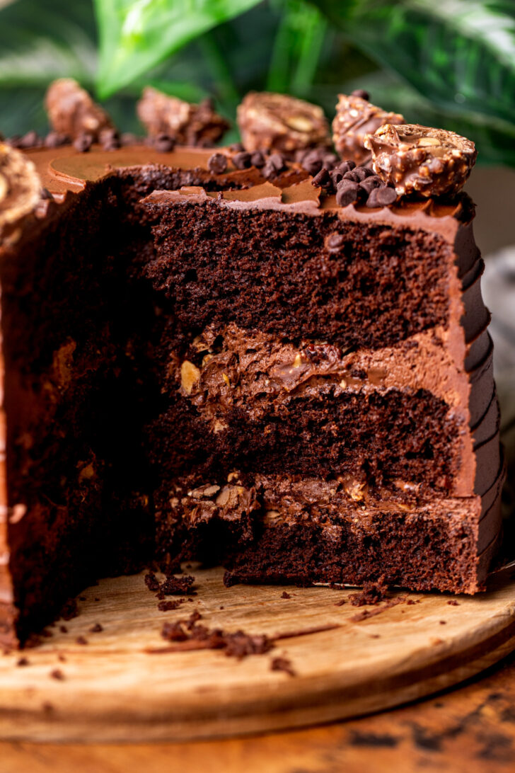 Taking a slice of ferrero rocher cake out of the cake.
