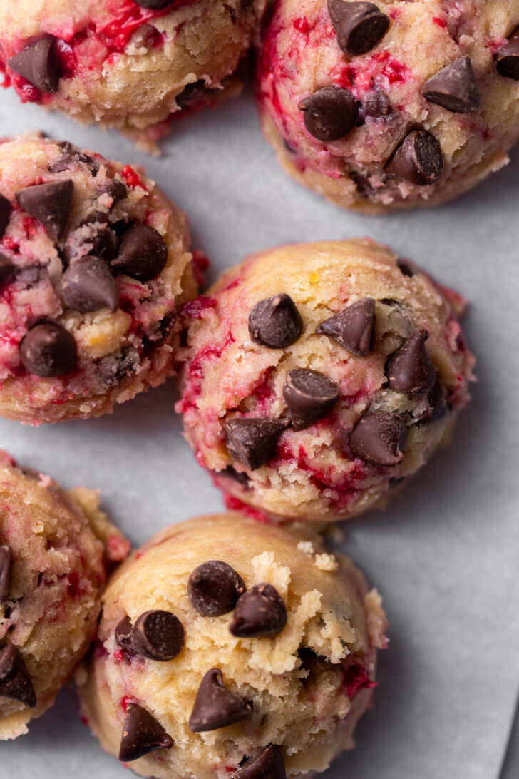 Cookie dough balls on a cookie sheet.