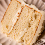 One slice of vanilla cake on a plate.