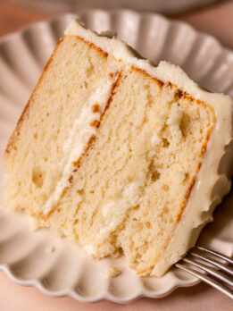 One slice of vanilla cake on a plate.