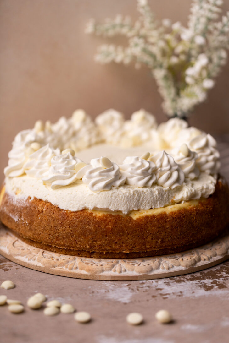 Decorated cheesecake on a platter.