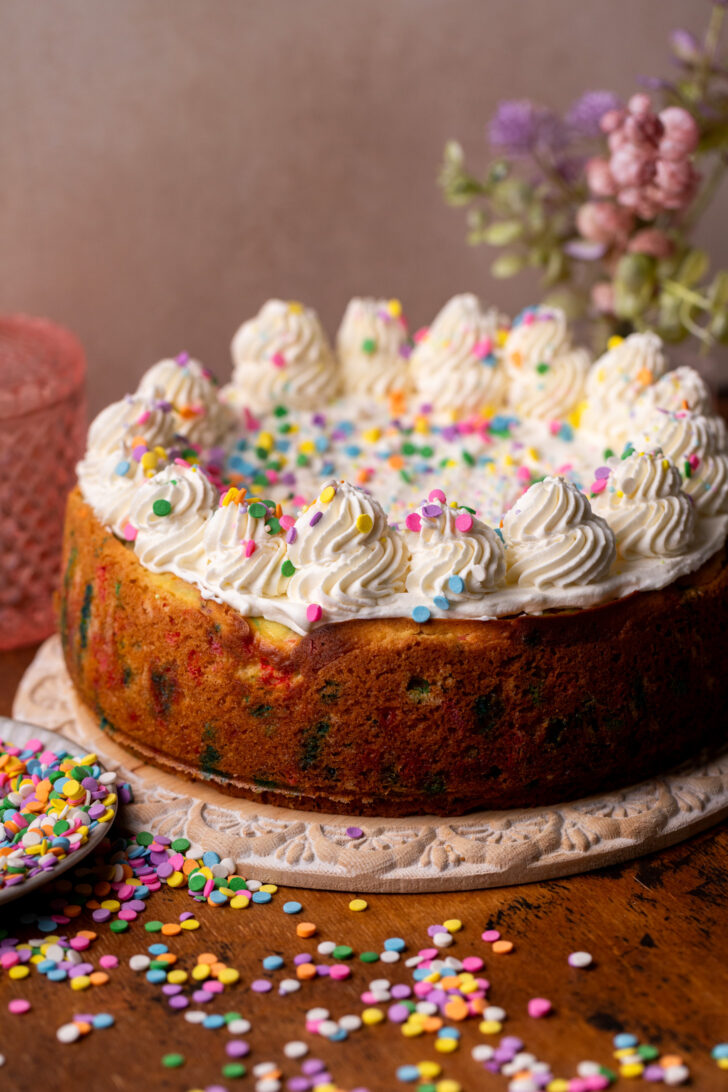 Decorated cheesecake on a platter.