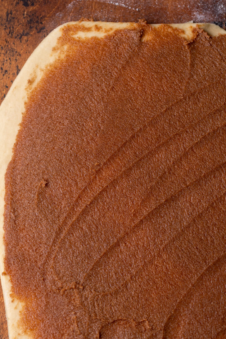 Cinnamon filling on top of rolled out dough.