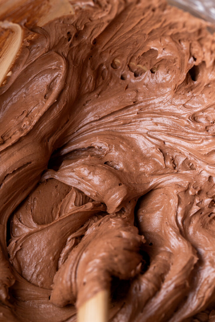 Chocolate fudge frosting in a glass bowl.