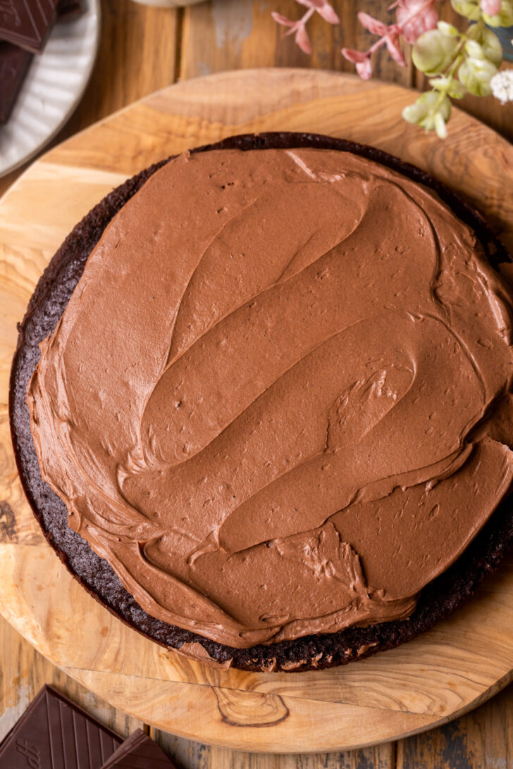 Frosting on top of a cake layer.