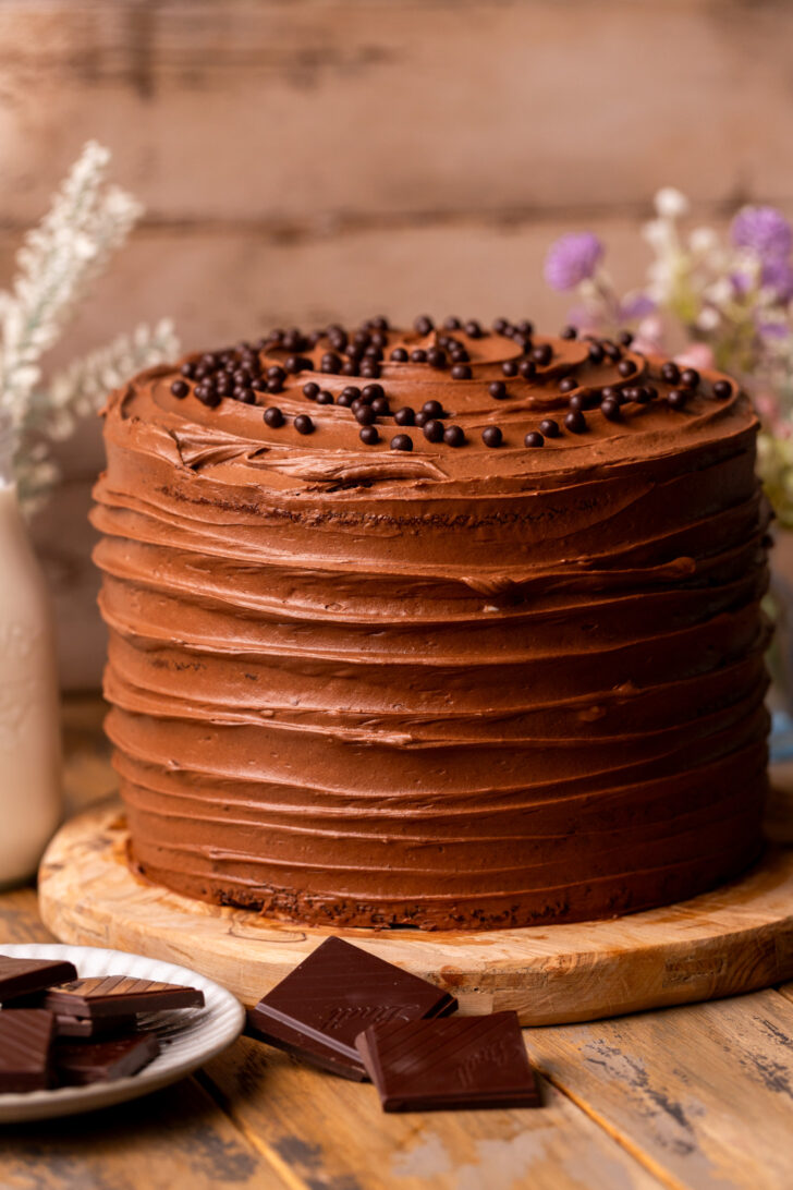 Decorated cake on a wood board.
