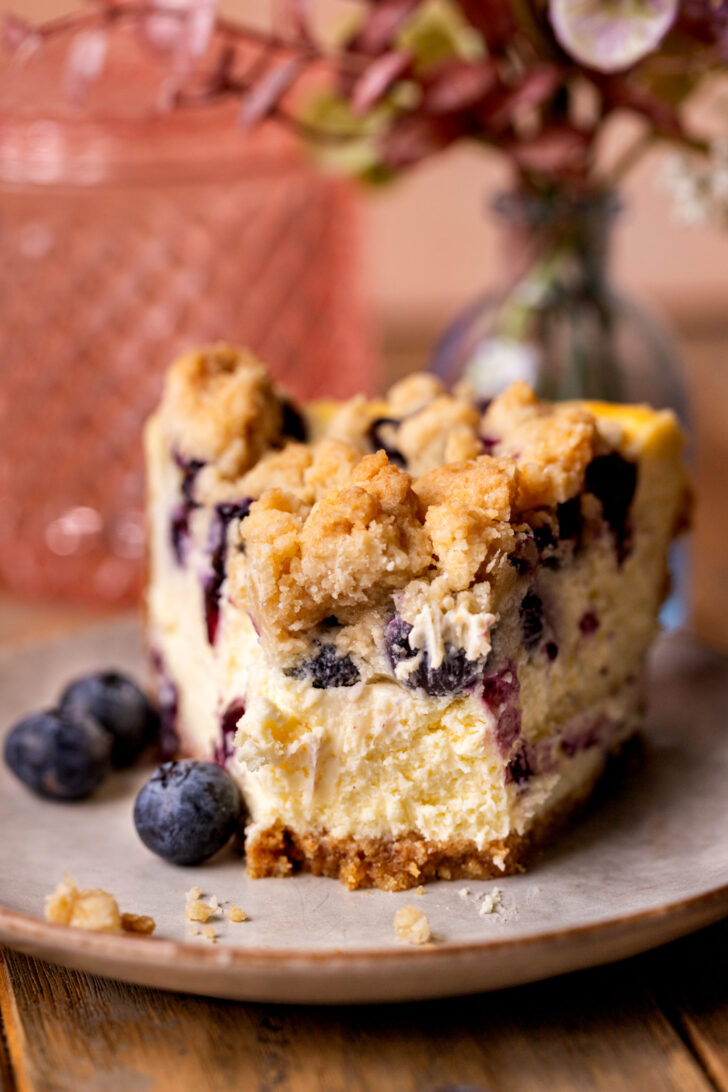 Bite missing from slice of cheesecake.