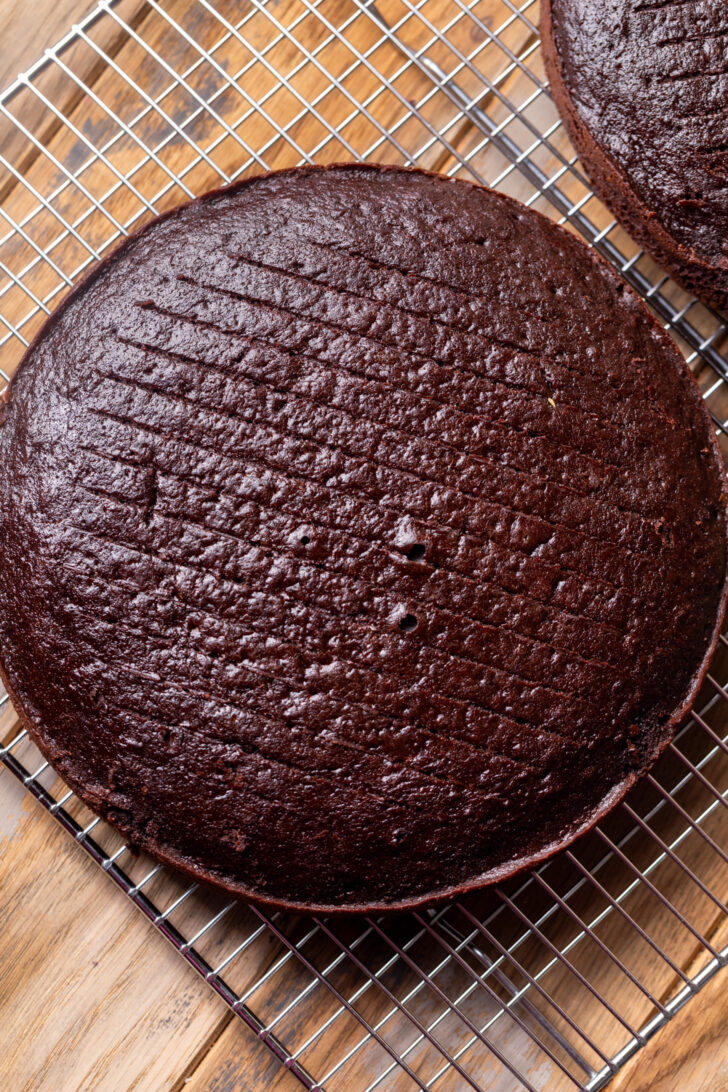 Baked chocolate cake layers on a wire rack.