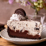 A slice of no bake Oreo pie on a plate.