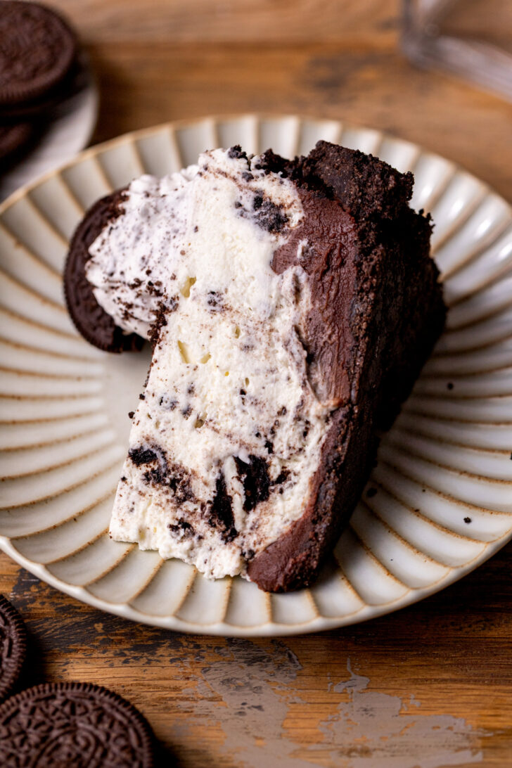 A slice of pie on it's side on a plate.