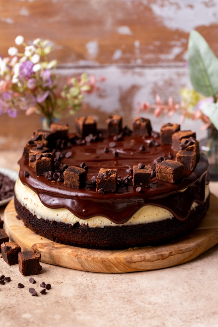 Decorated cheesecake on a wood board.