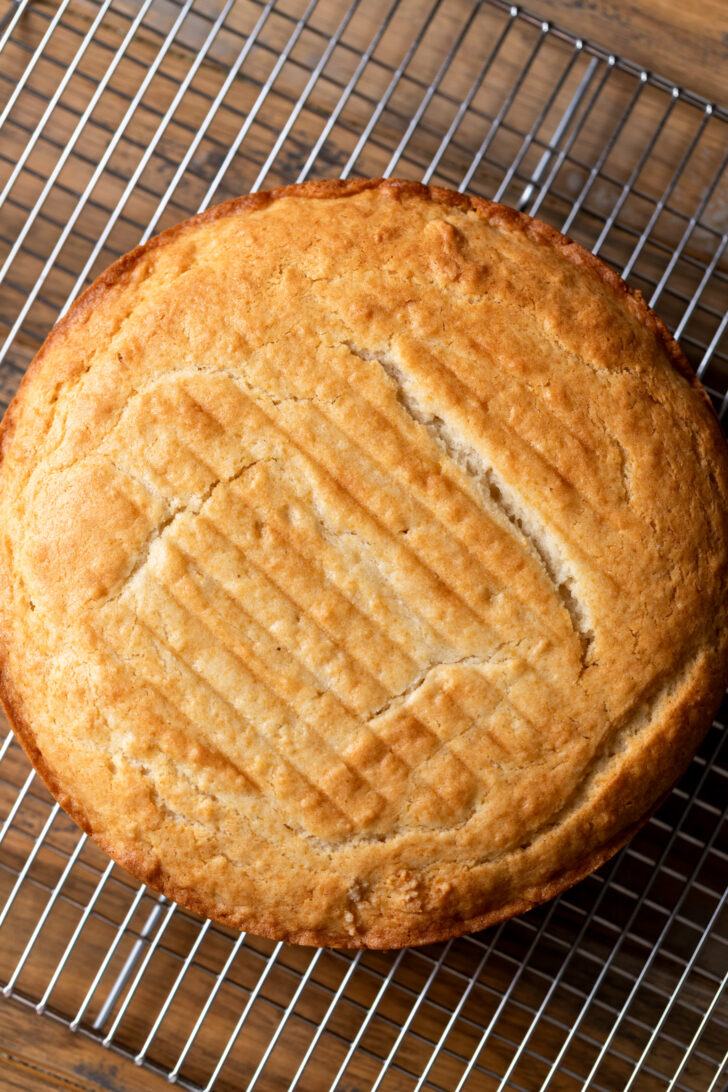 Baked cake layer on a wire rack.
