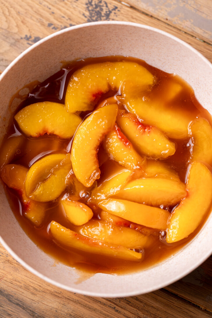 Cooked peaches in a bowl.