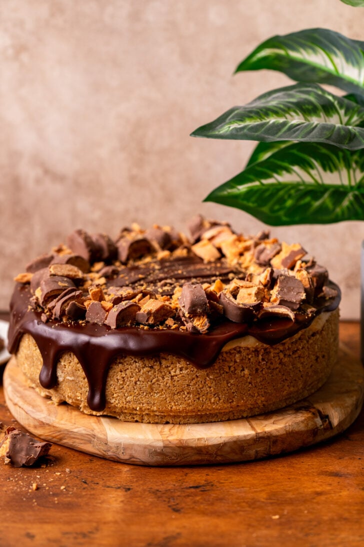 Decorated pie on a wood platter.