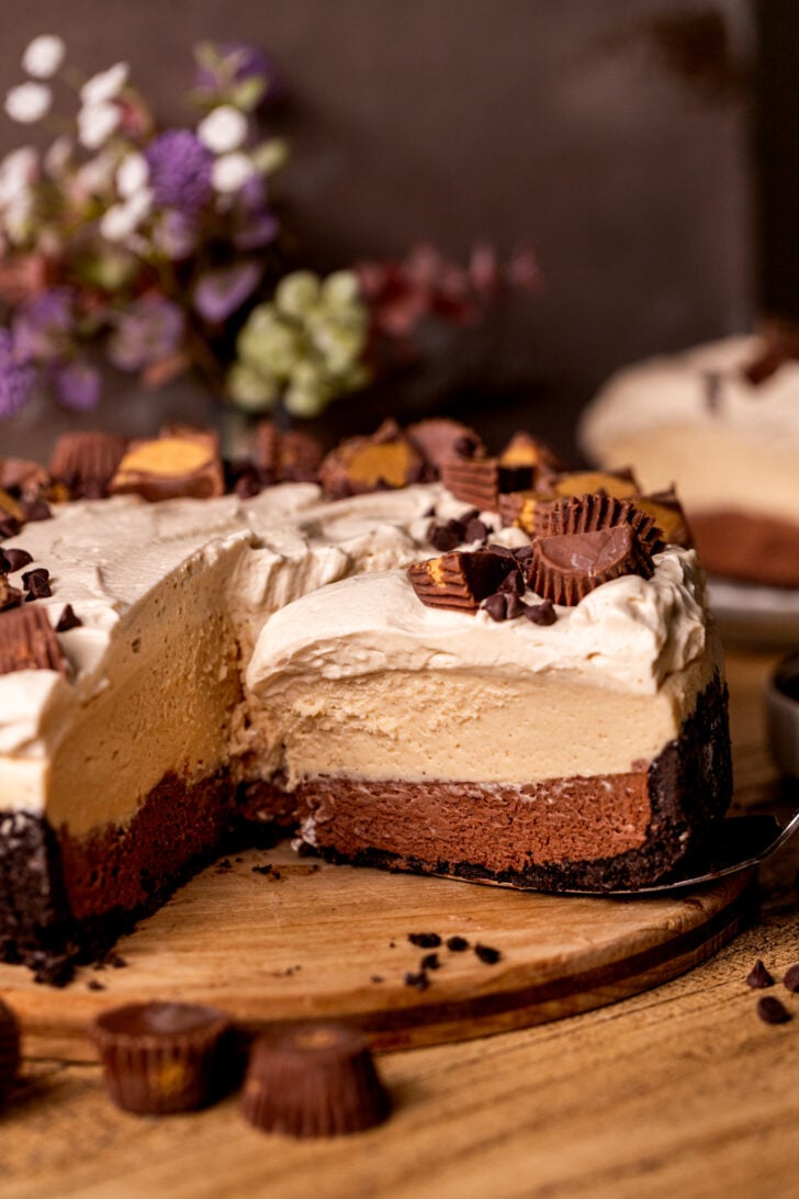 A slice taken out of the chocolate peanut butter pie.
