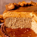 Close up of biscoff mousse cake on a wood board.