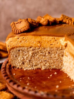 Close up of biscoff mousse cake on a wood board.