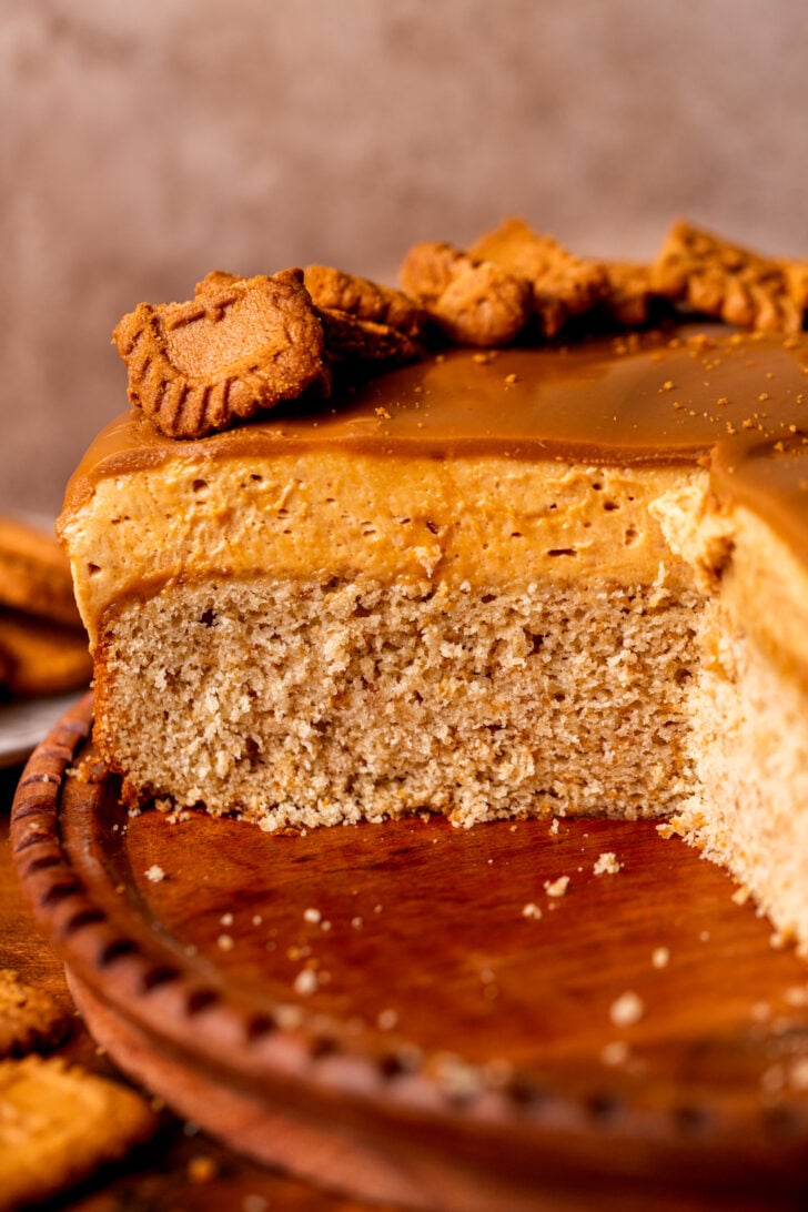Close up of biscoff mousse cake on a wood board.