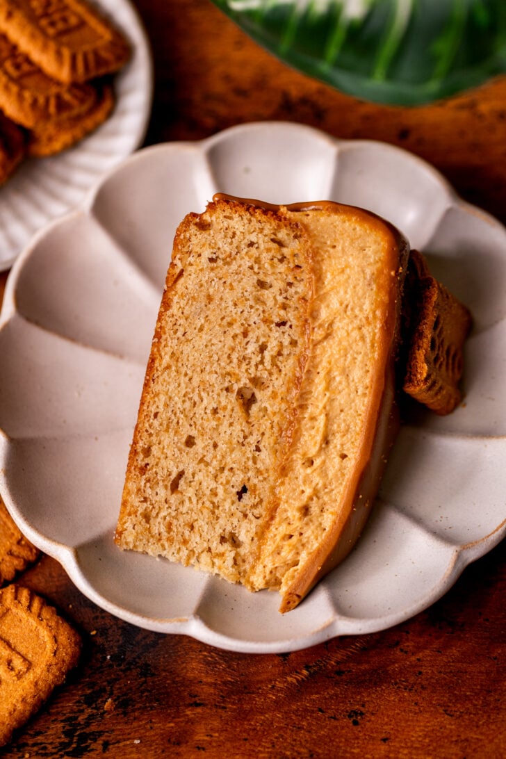 One slice of cake on it's side on a plate.