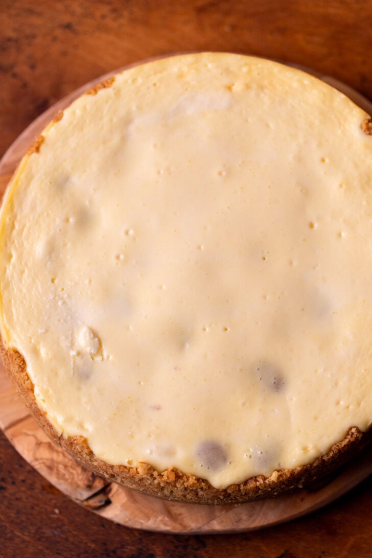Baked cheesecake on a wood board.