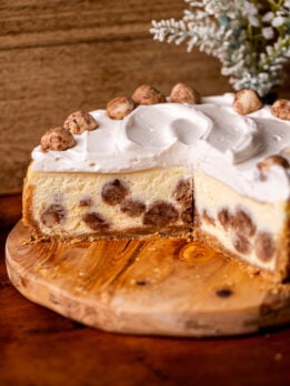 Snickerdoodle cheesecake on a wood board split open.