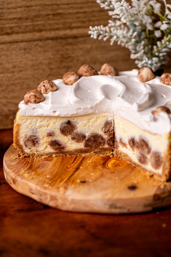 Snickerdoodle cheesecake on a wood board split open.