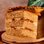 Open Biscoff cookie butter cake on a wood board.