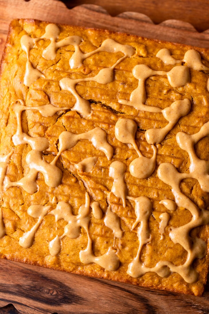 Poked cake on a wood board.