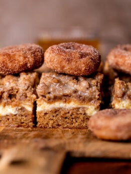 Apple cider coffee cake side view on a wood board.