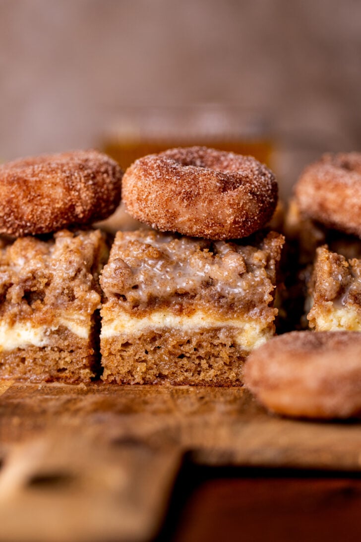 Apple cider coffee cake side view on a wood board.