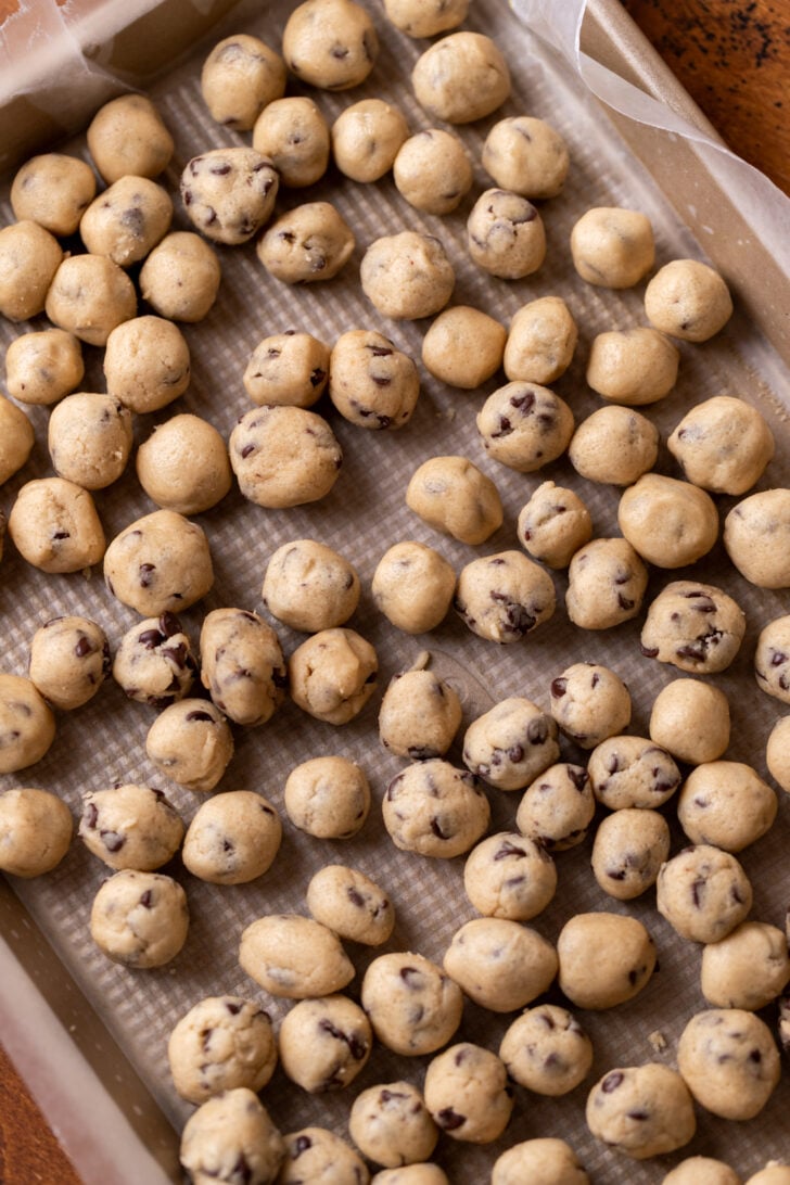 Cookie dough balls on a cookie sheet.