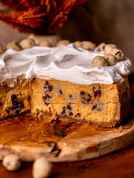 Close up of the side of the pumpkin cookie dough cheesecake.