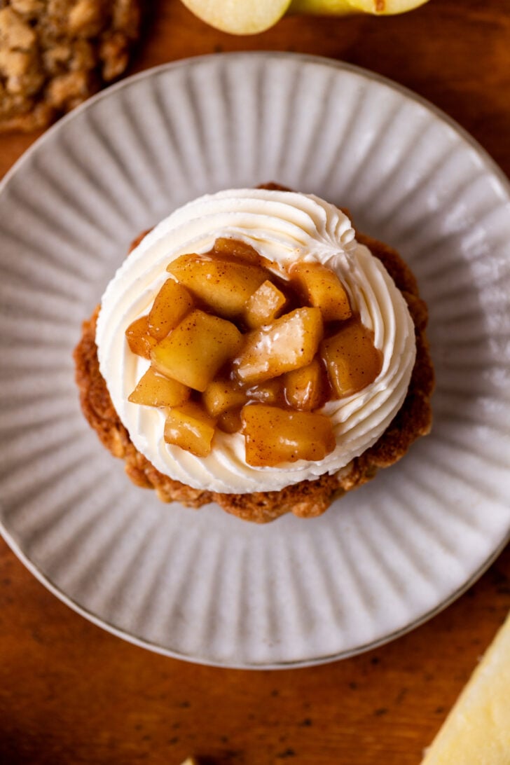 Apple pie filling on top of frosting on the cookie.