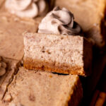 One slice of chai cheesecake bars on its' side.