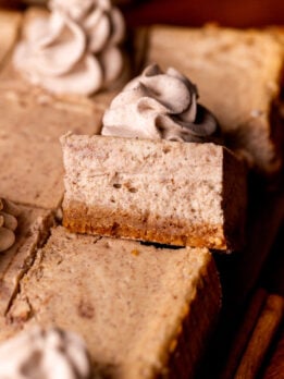 One slice of chai cheesecake bars on its' side.