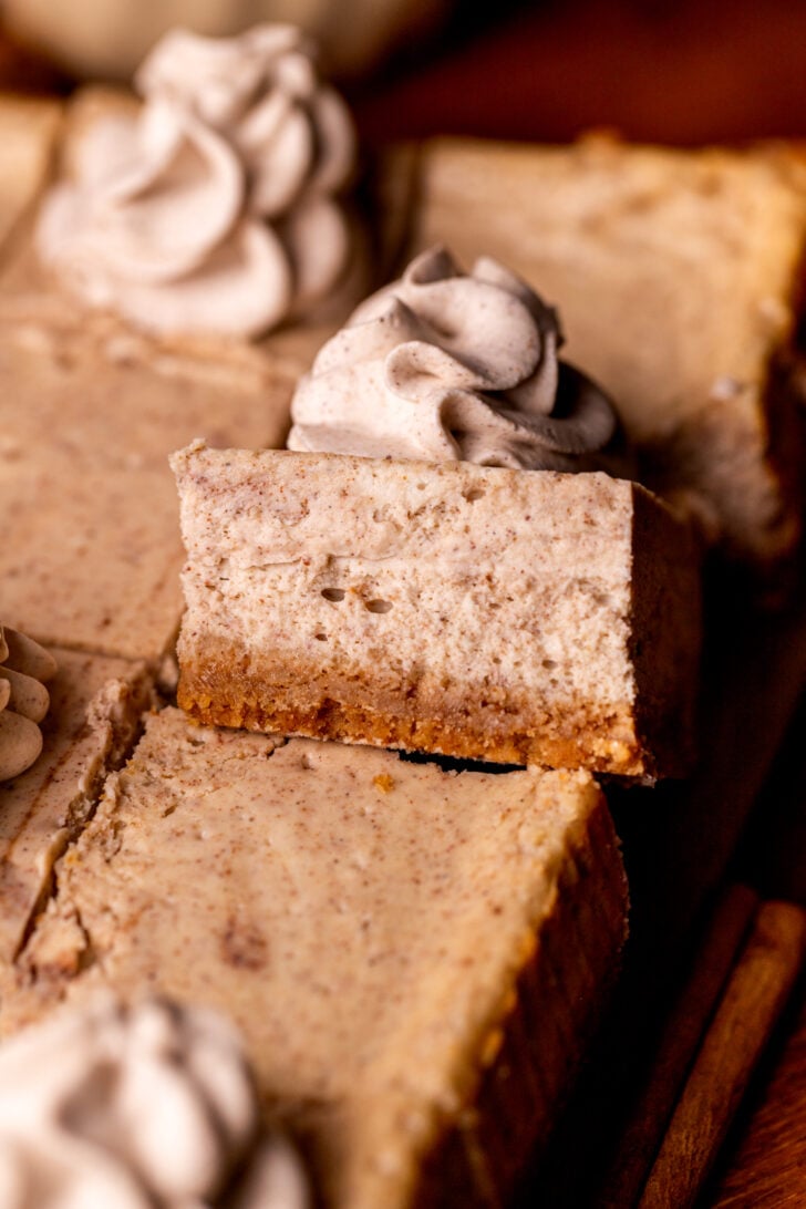 One slice of chai cheesecake bars on its' side.