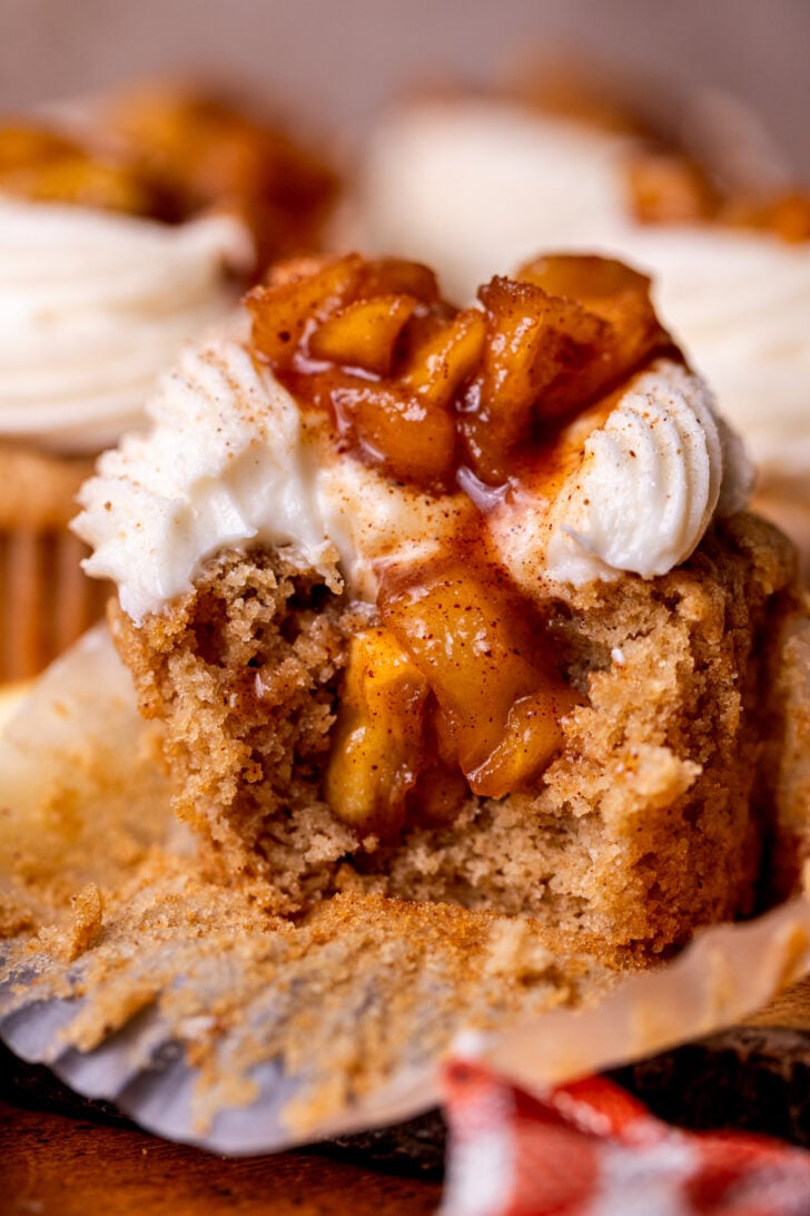 Bite missing from apple pie cupcakes.