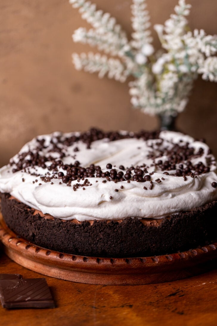 Decorated pie on a wood platter.